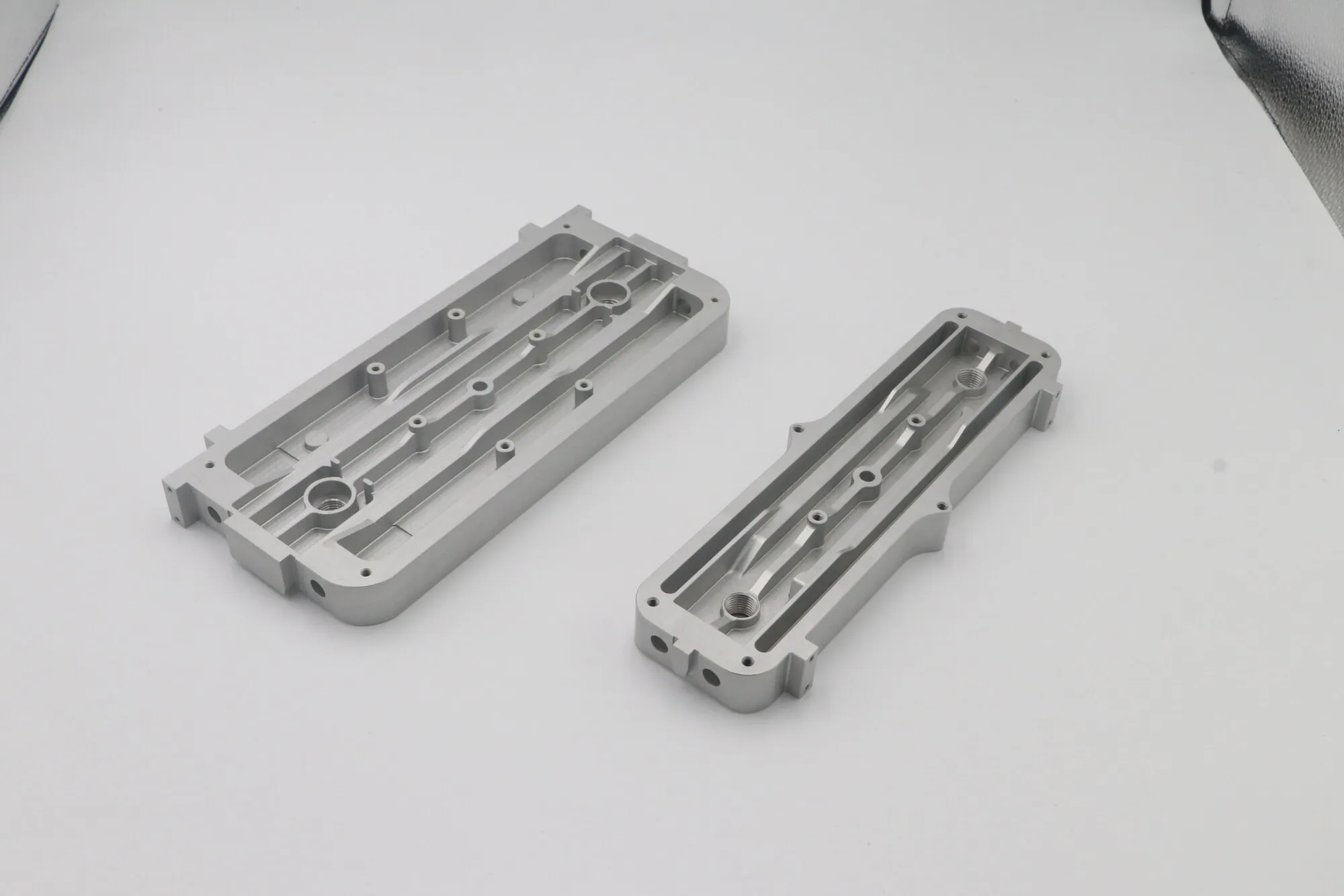 CNC milled aluminum cover plates with internal channels and sealing grooves