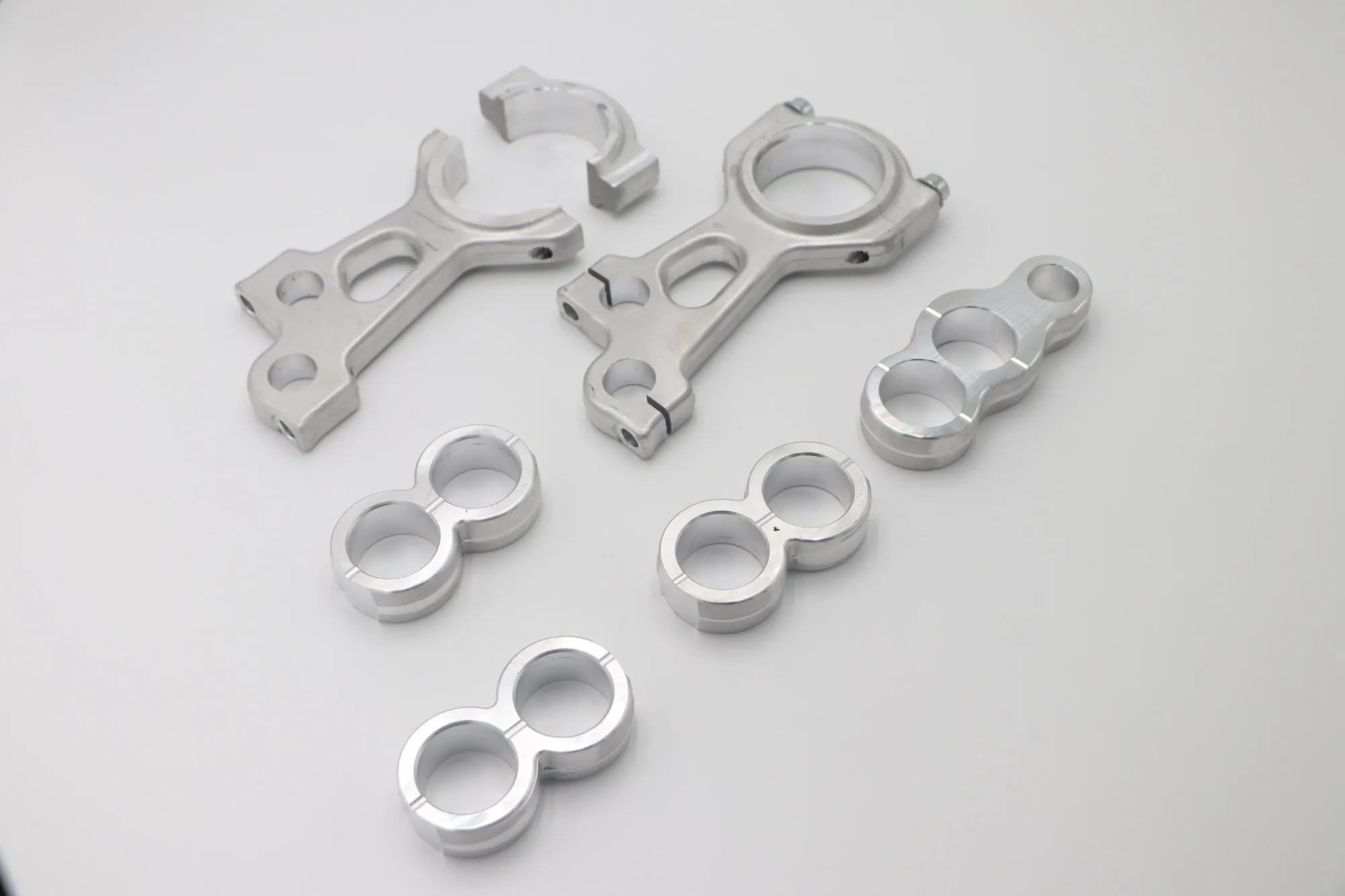Forked twin-bore CNC milled aluminum linkage brackets