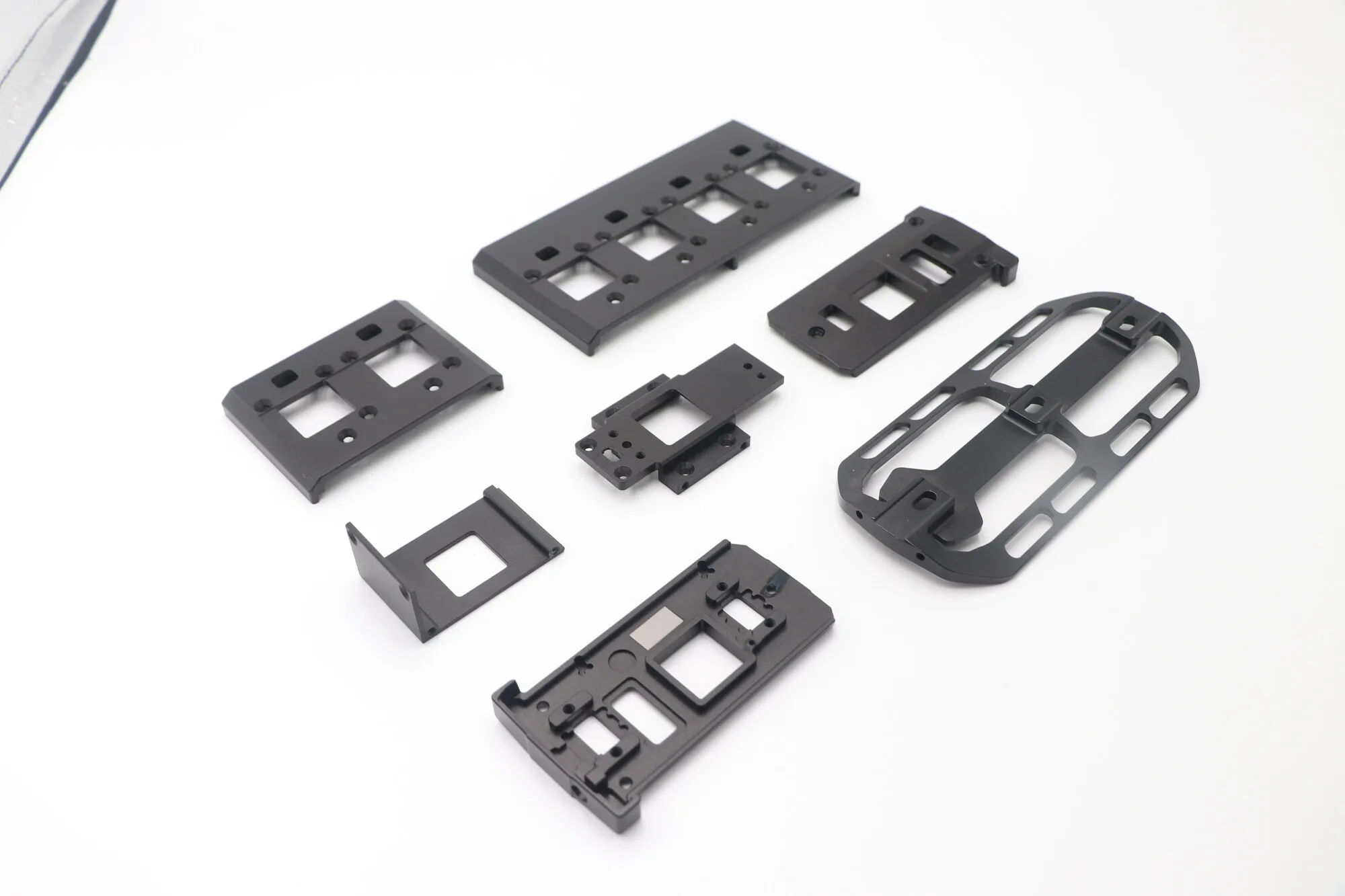 Set of lightweighted black anodized CNC milled aluminum plates with milled pockets