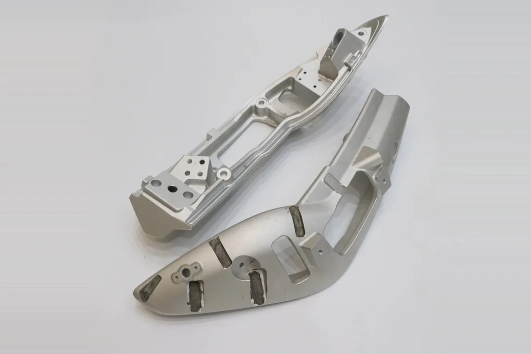 Pair of five-axis machined aluminum structural frames with compound angled faces