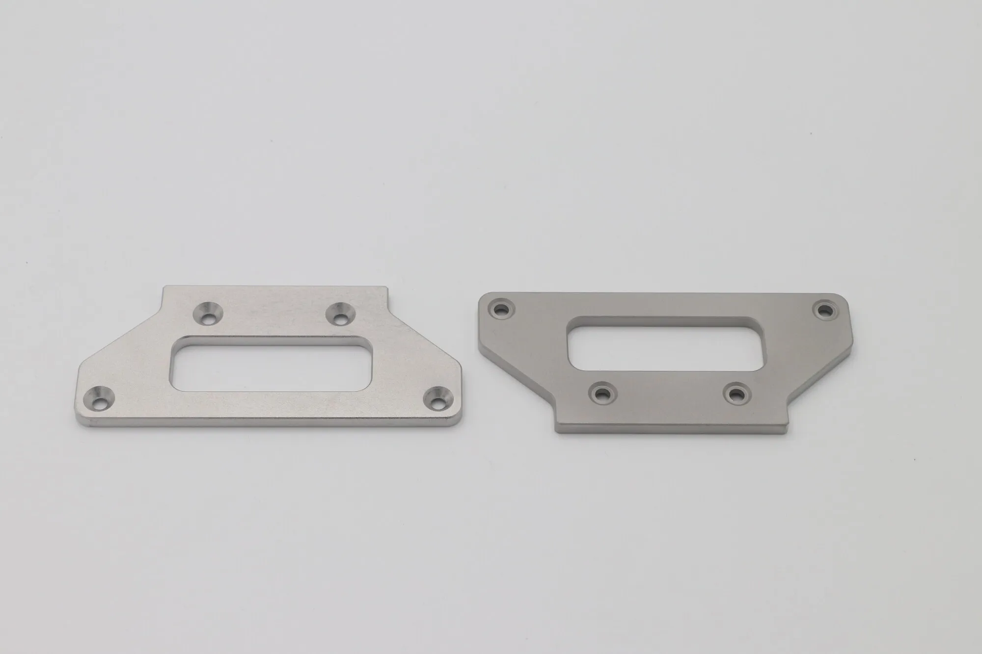 CNC milled steel mounting plates with machined apertures and countersinks