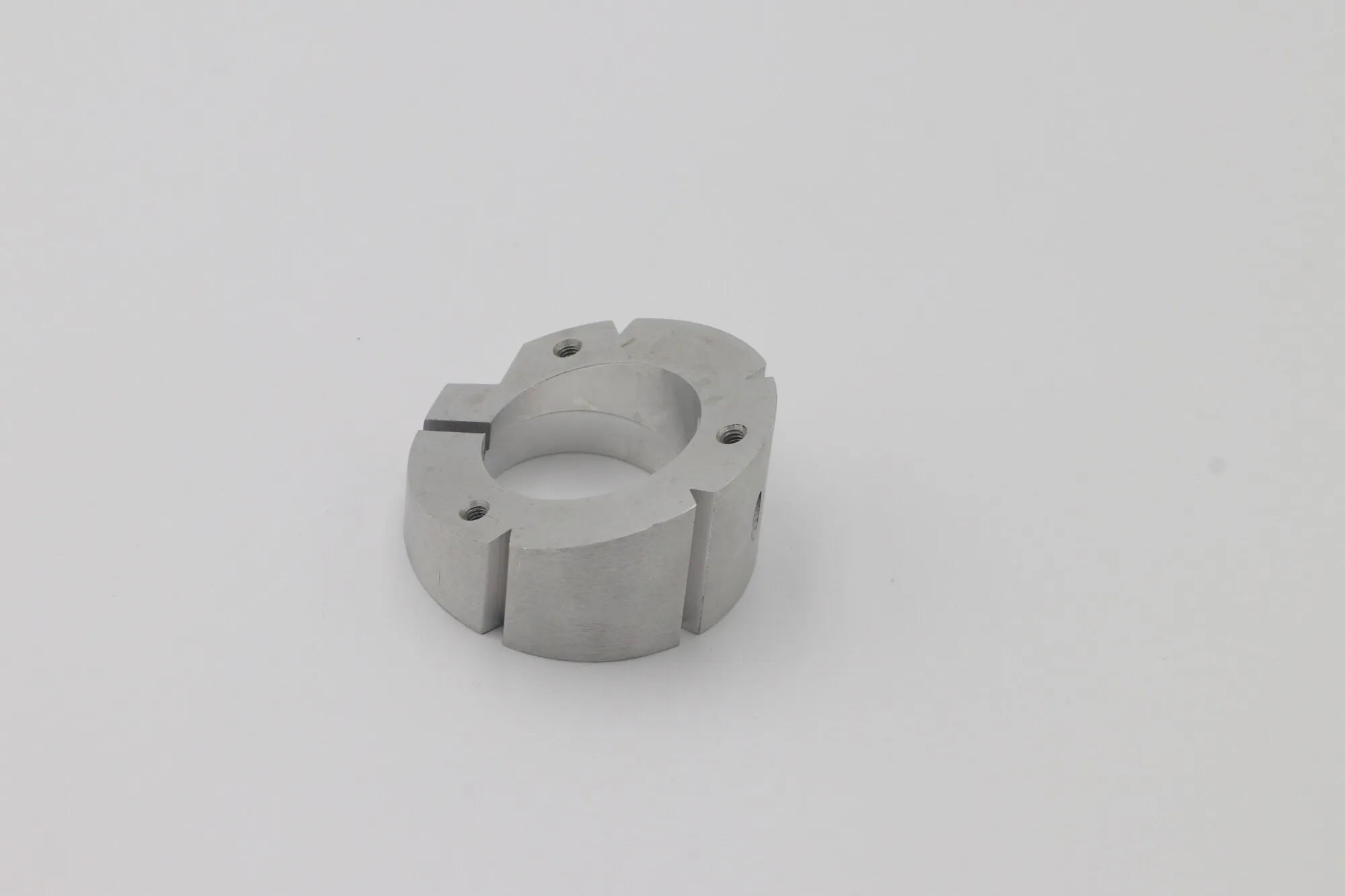 Machined aluminum split clamp collar with slotted bore and tapped clamping holes